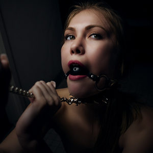 Kylie Grace Model Grasping Chain While Gagged